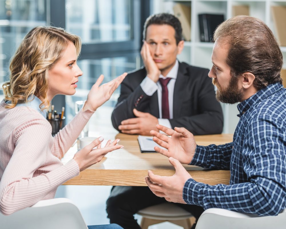 side-view-of-couple-arguing-at-workplace-in-lawyer-office.jpg